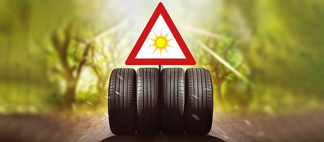 cetiri-letnje-gume-na-putu Četiri letnje gume poređane na putu, iznad njih je trouglasti saobračajni znak na kom je nacrtano sunce